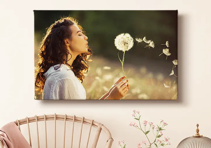 portrait of a girl on canvas print holding a flower and blowing at it