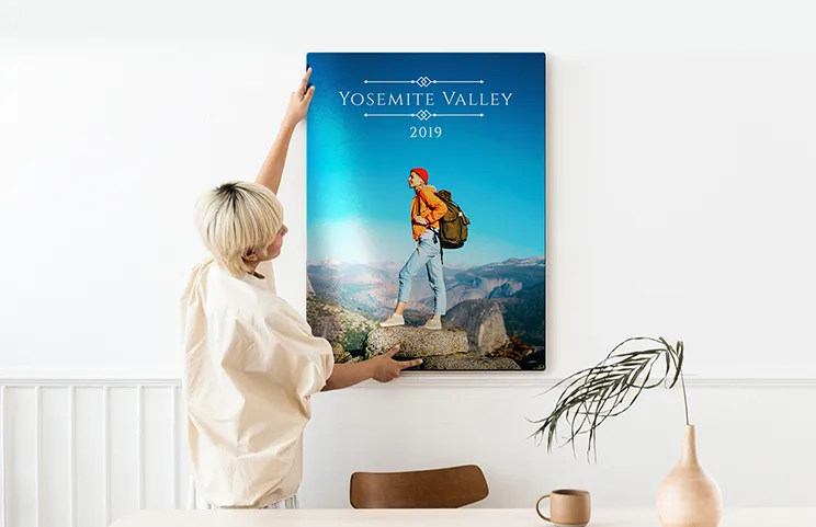 Aluminium photo print of a moutain and a lake being held by woman made by Printerpix