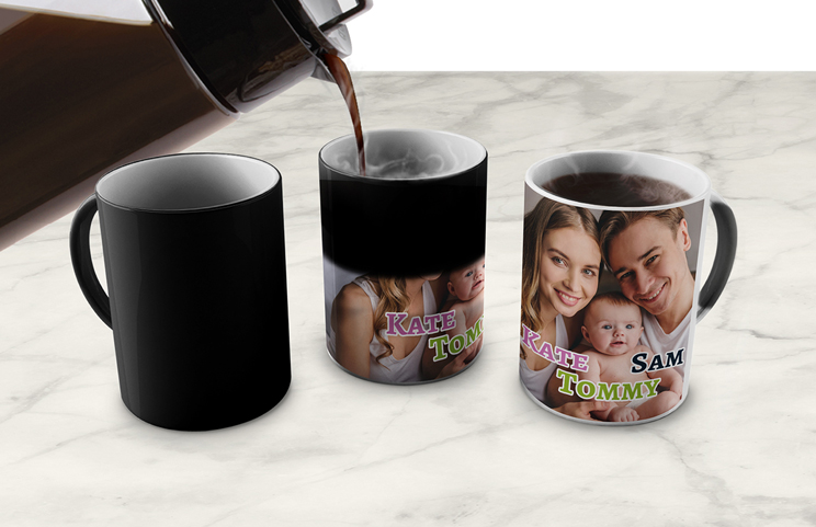 Magic Mug|Three mugs, being filled with hot water to reveal a family.|Young boy holding custom designed magic mug with photo of himself on|Magic mug with picture of cat on having tea poured into it on desk|Couple holding two heat changing magic mugs with custom text by Printerpix|Three mugs: one empty (blank), one half full (half an image) and one full (full image)|Grandad and grand daughter holding hands with personalised mug with photo of grand daughter||||